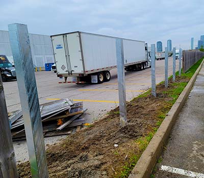 Image of commercial steel fence posts set up in an industrial area