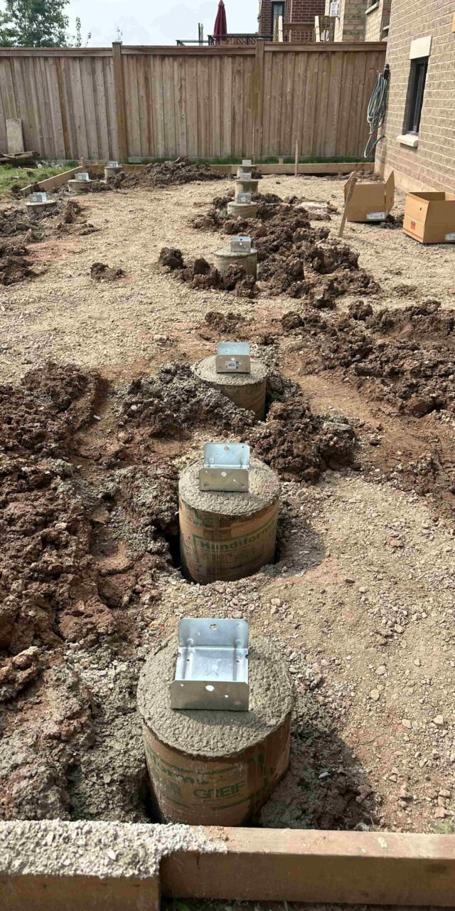 https://post2fence.com/wp-content/uploads/2026/04/concrete-deck-footings-installation-greater-toronto-area-post2fence-640x1280.jpg